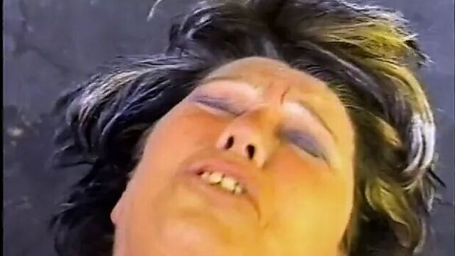 Watch an older woman grab his nuts and suck his dick in public